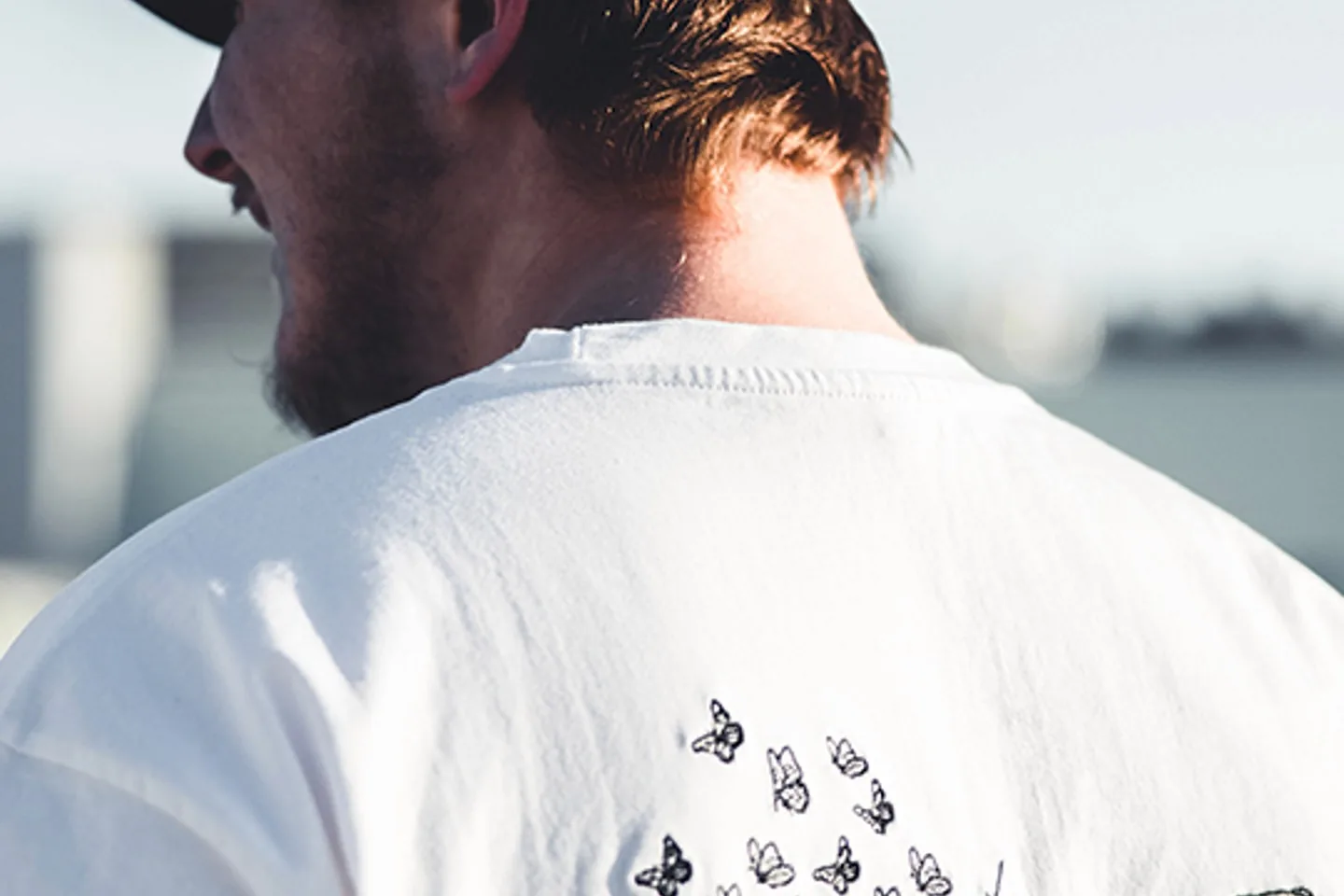 man wearing a simple shirt - Printful Alternatives