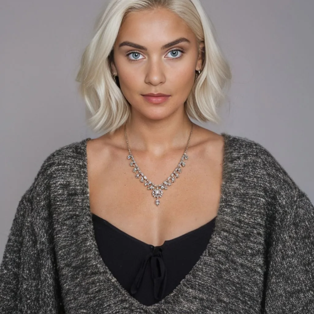 25 year old caucasian model wearing detailed necklace, mid-range shot includes shoulders - this time with blonde hair