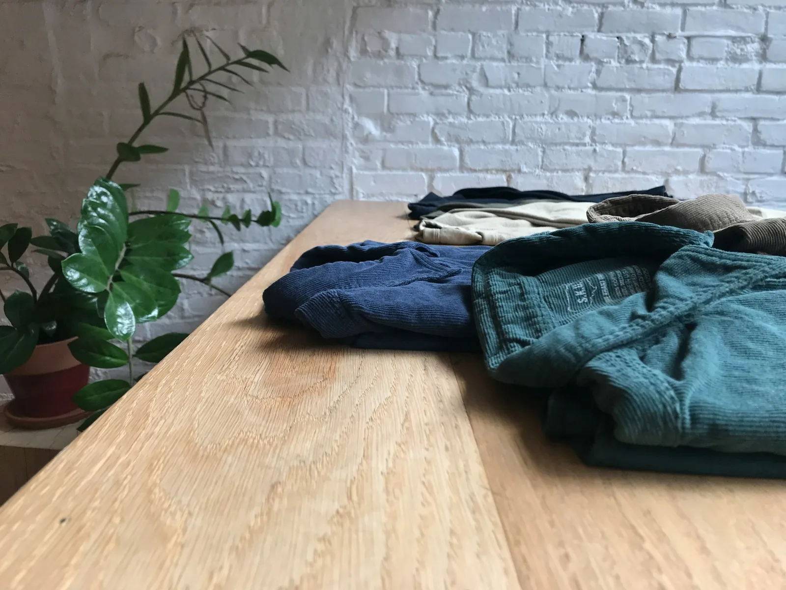 jackets on table - How To Take Pictures Of Clothes To Sell Online
