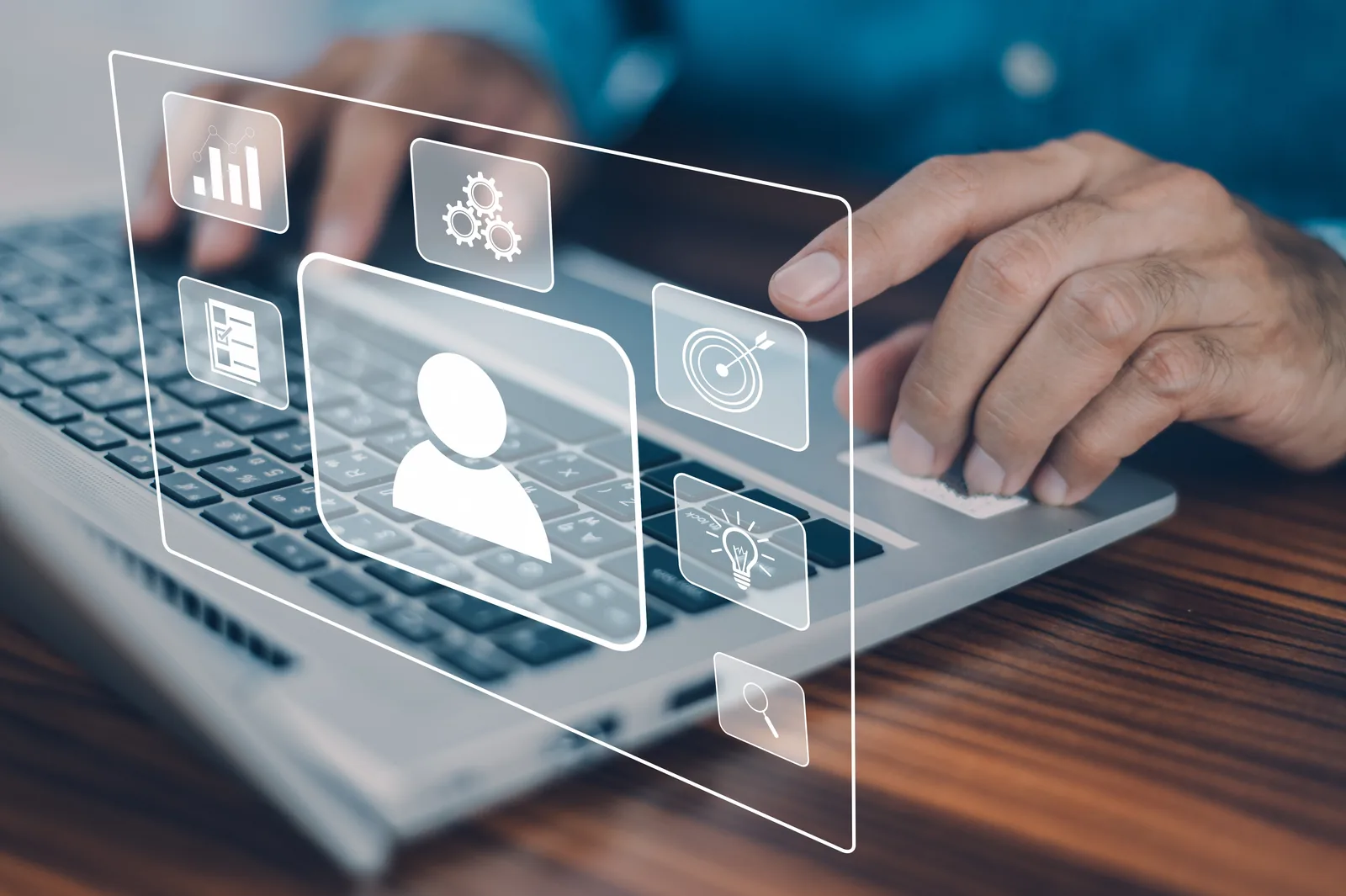 Person using a laptop with floating customer profile and analytics icons, representing ecommerce customer segmentation