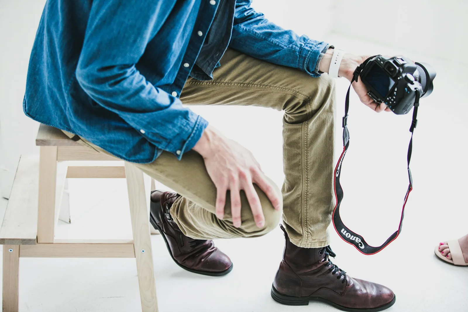 person holding a camera - How To Take Pictures Of Clothes To Sell Online