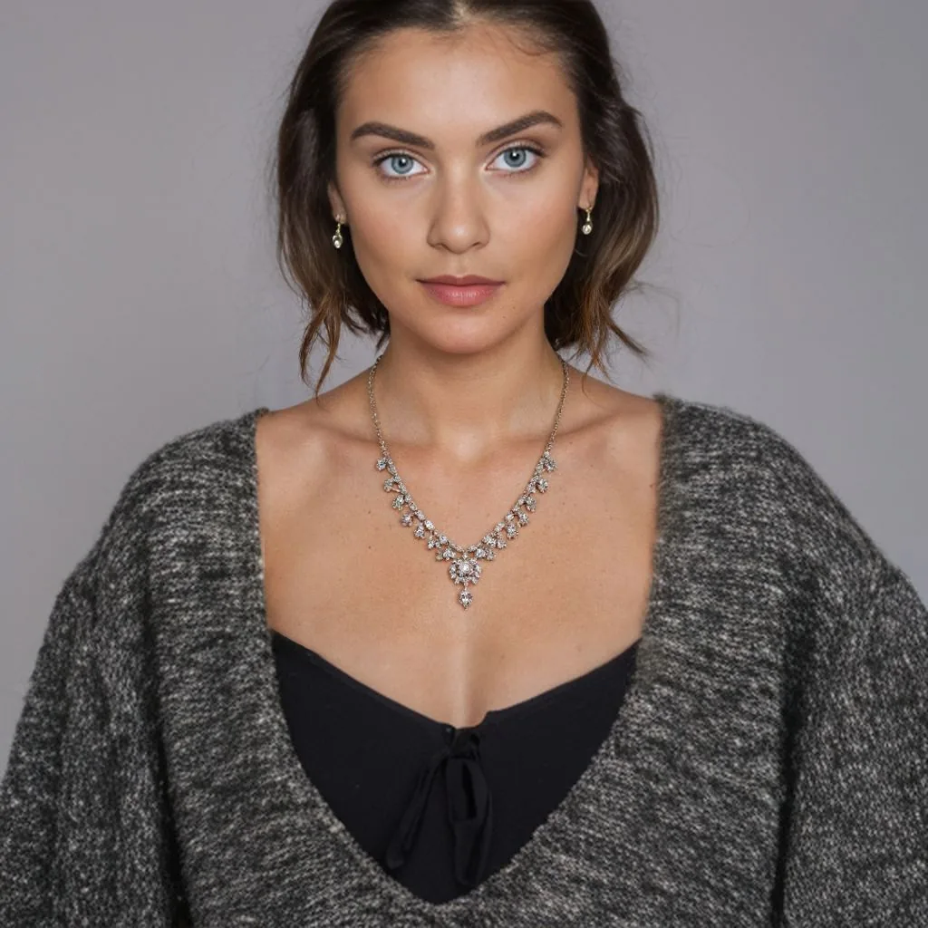25 year old caucasian model wearing detailed necklace, mid-range shot includes shoulders