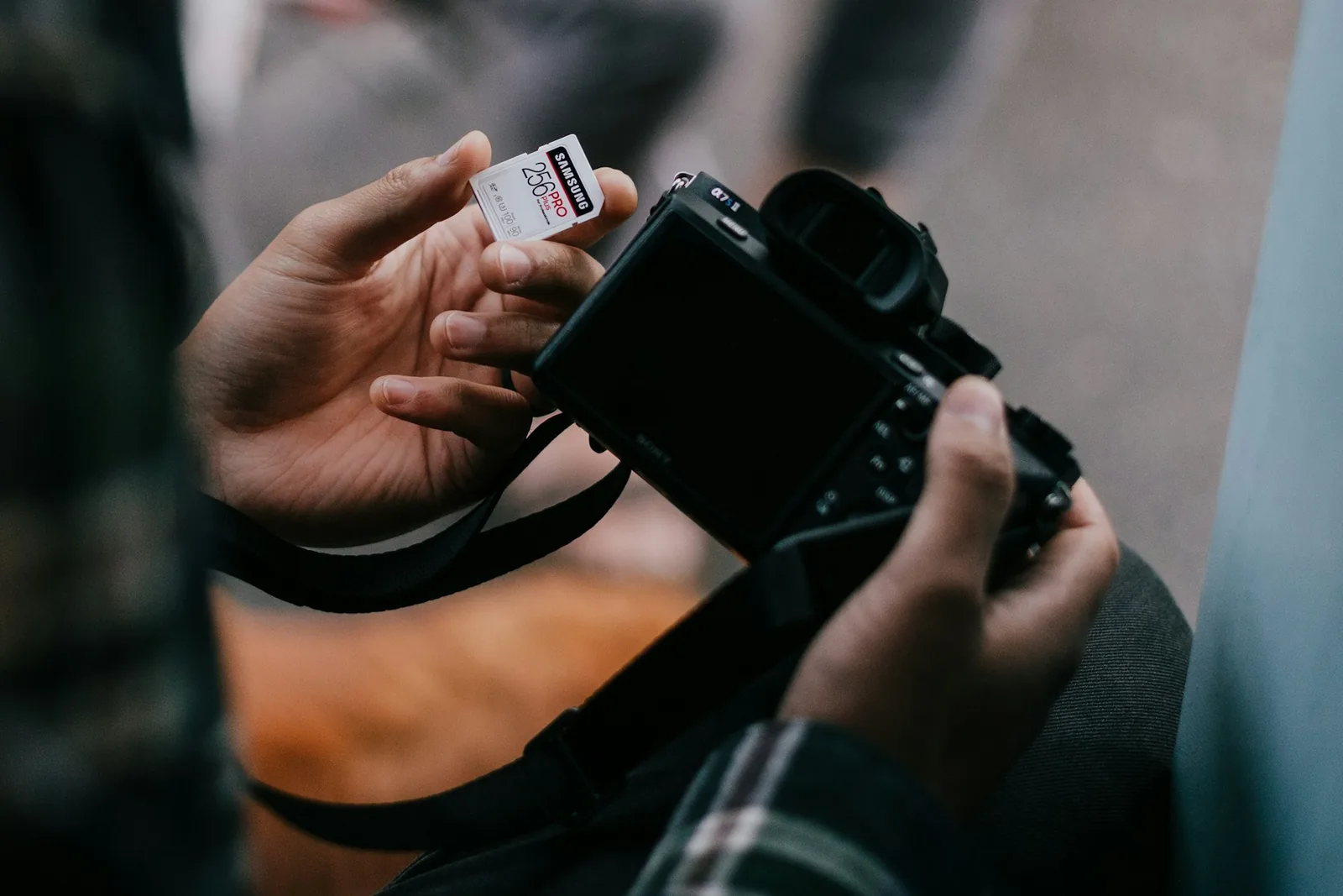 man adding memory card - Best Camera For Product Photography