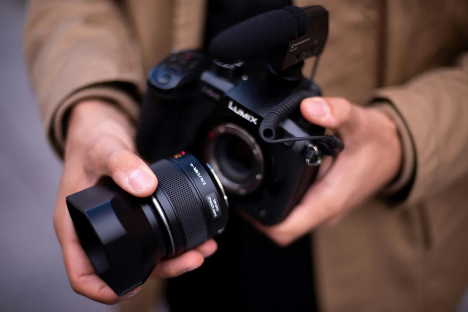 Man Holding Camera - Best Lens for Jewelry Photography