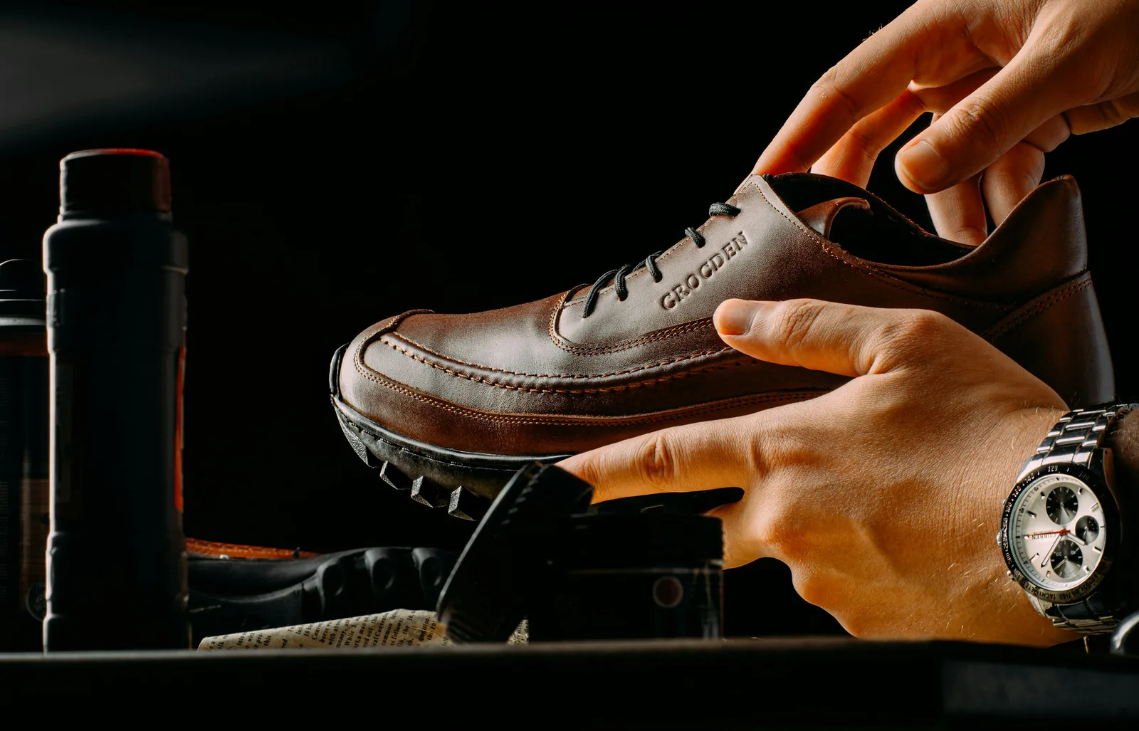 person holding a shoe - Shoe Product Photography