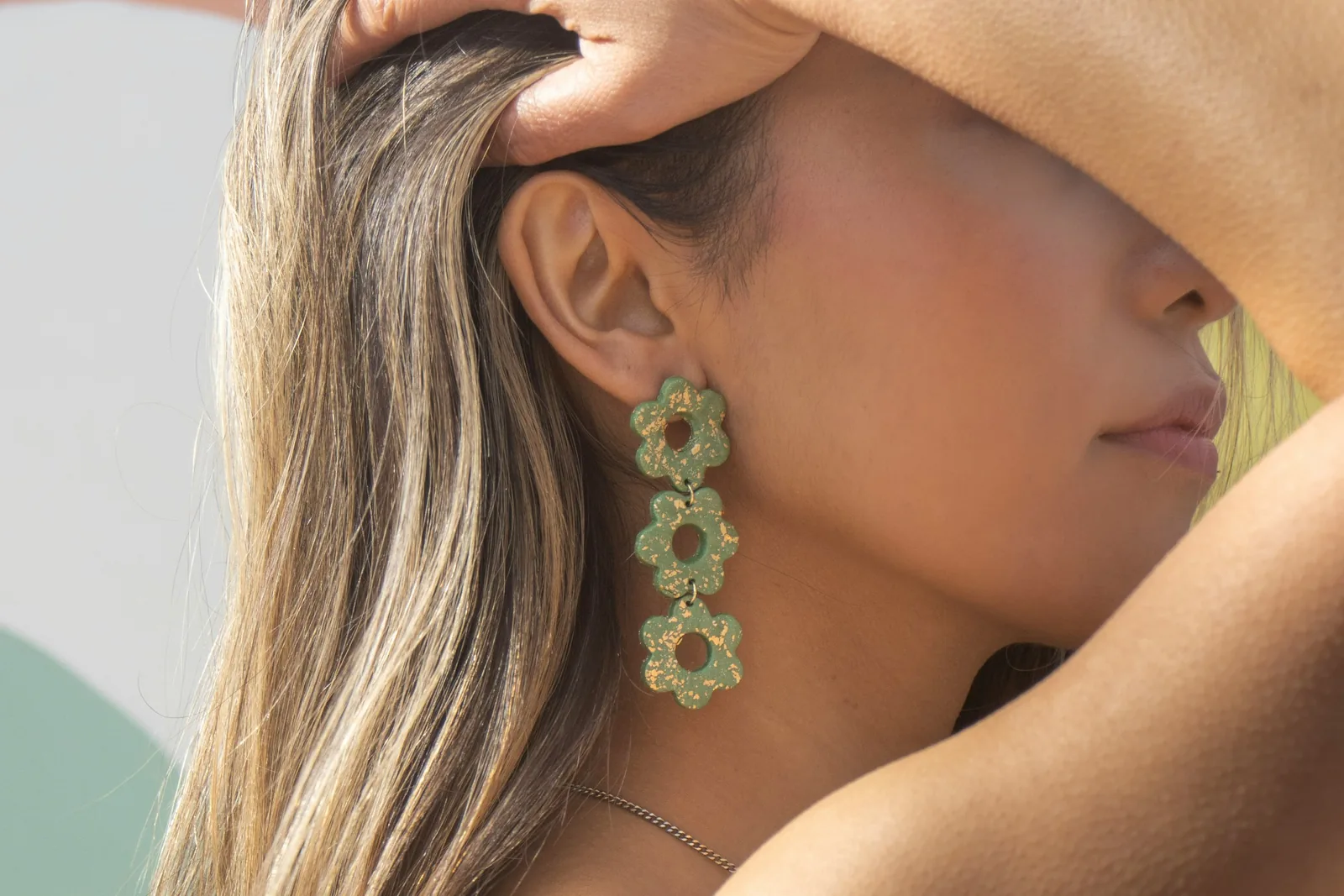 woman showing off her earrings - Earring Photography